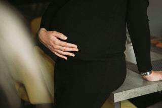 pregnant woman touching belly highlighting importance of non toxic lifestyle choices